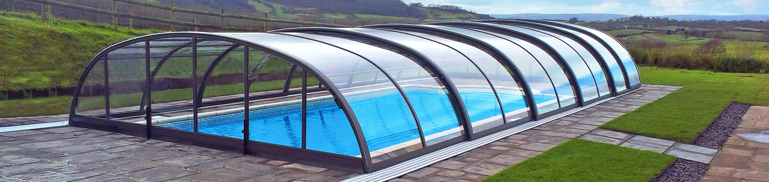 Low profile retractable pool enclosure that is classified as temporary structure